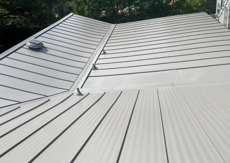 Solar attic fan installed on a metal roof for Roof Ventilation in Olympia